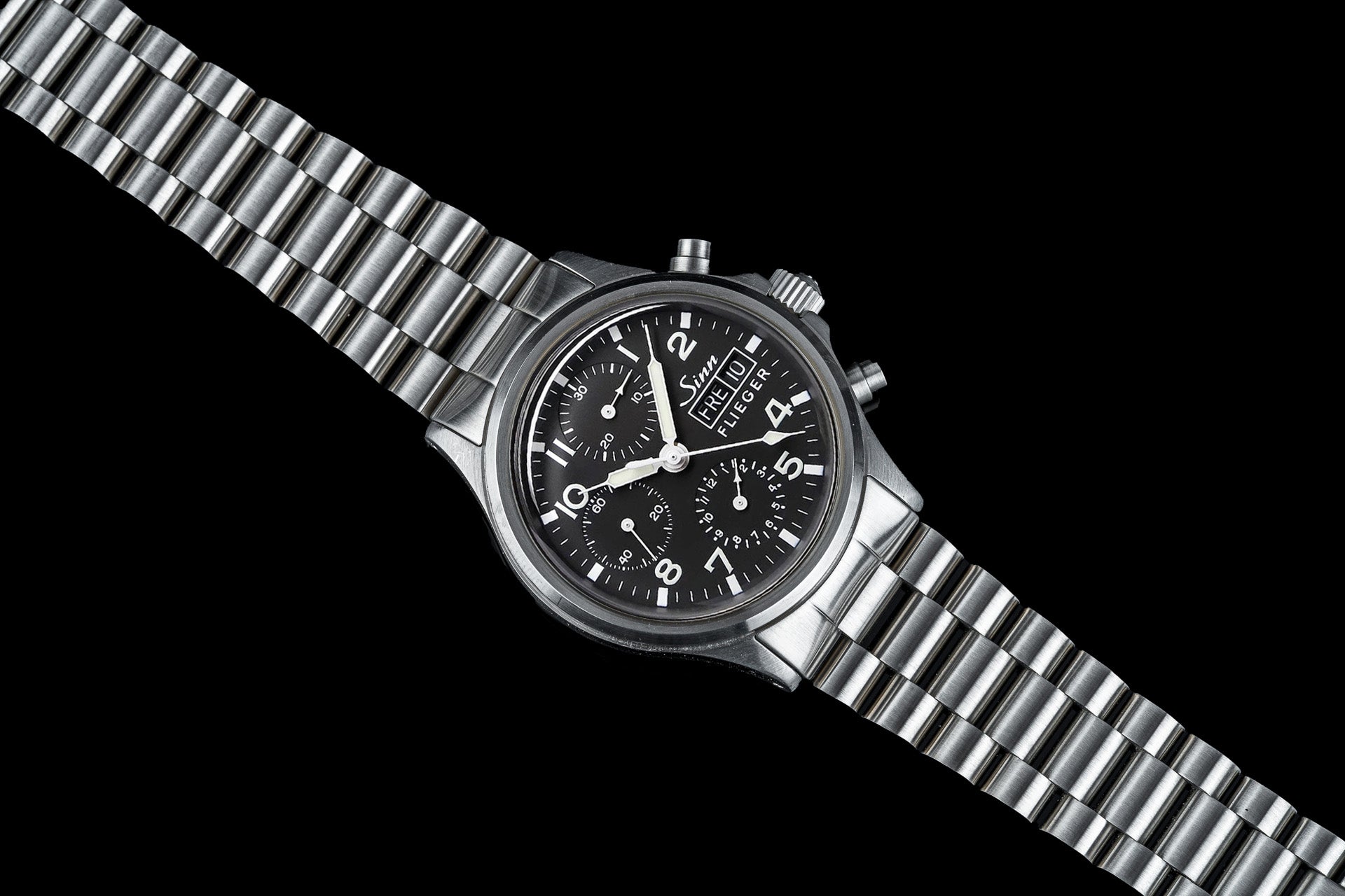 Sinn Flieger 356 chronograph watch with black dial and stainless steel bracelet on black background