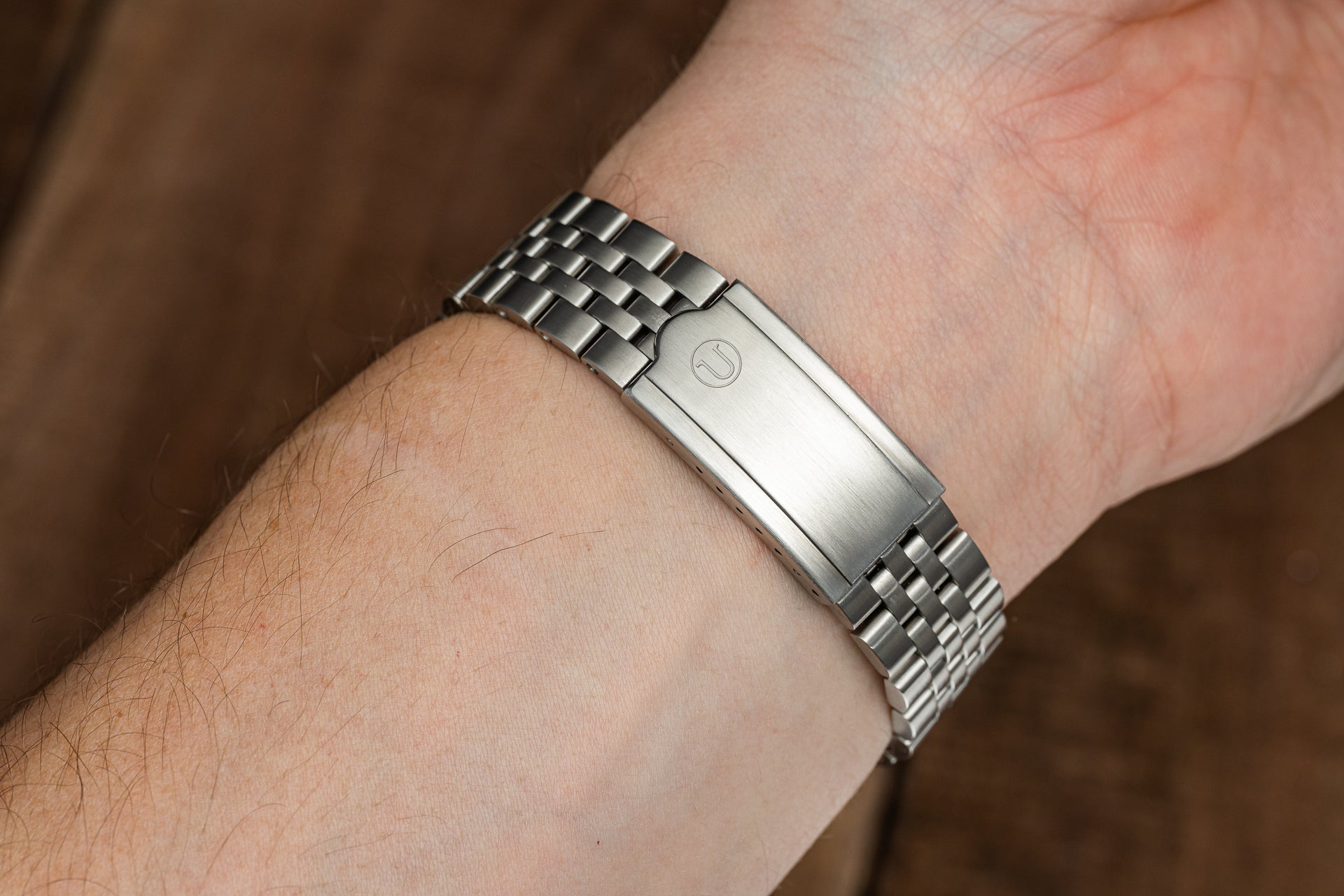 Stainless steel watch bracelet with integrated links and polished clasp worn on wrist, compatible with Seiko Slim Turtle models