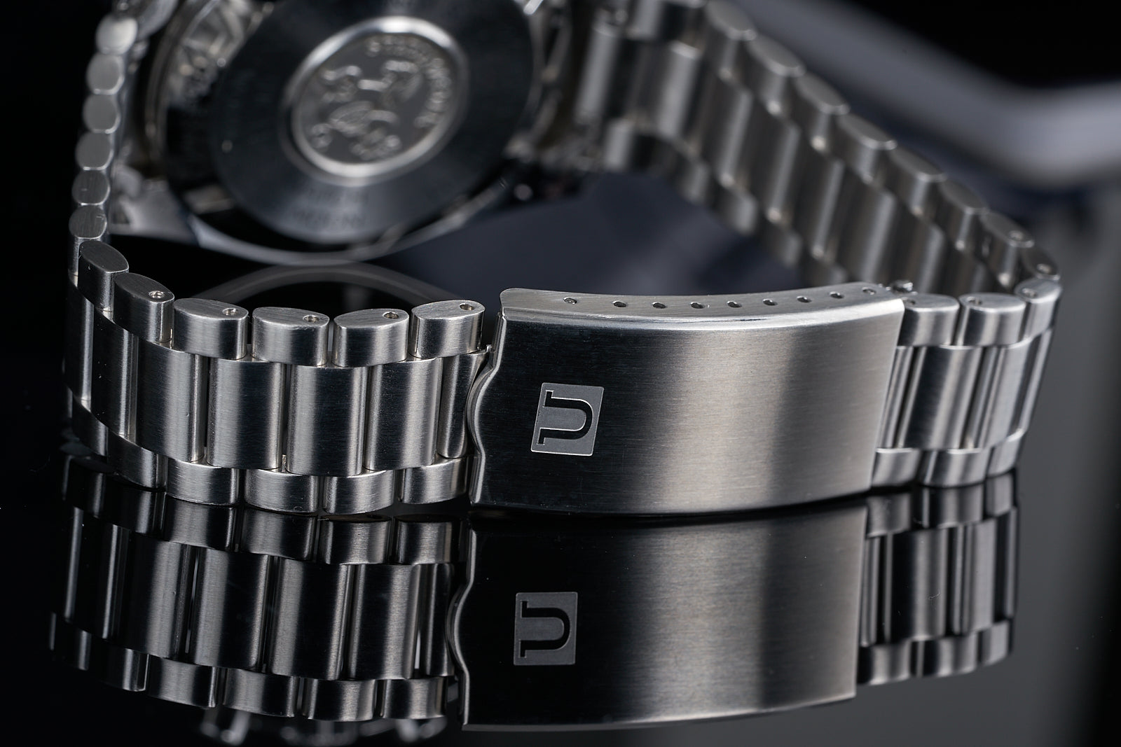 Stainless steel watch bracelet with solid links and deployant clasp for Omega Speedmaster, close-up detail view