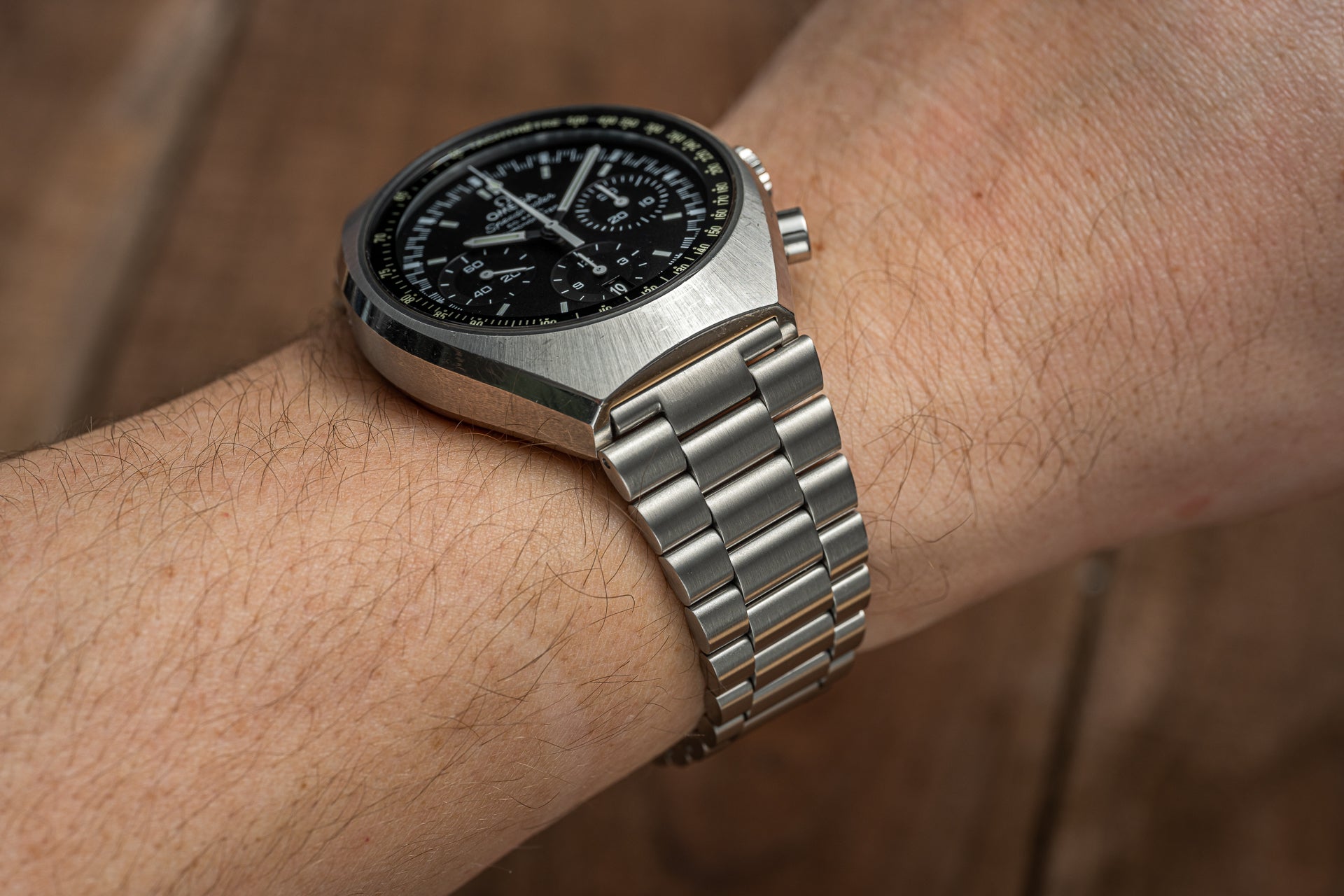 Omega Speedmaster Mark II chronograph watch with black dial and stainless steel bracelet worn on wrist