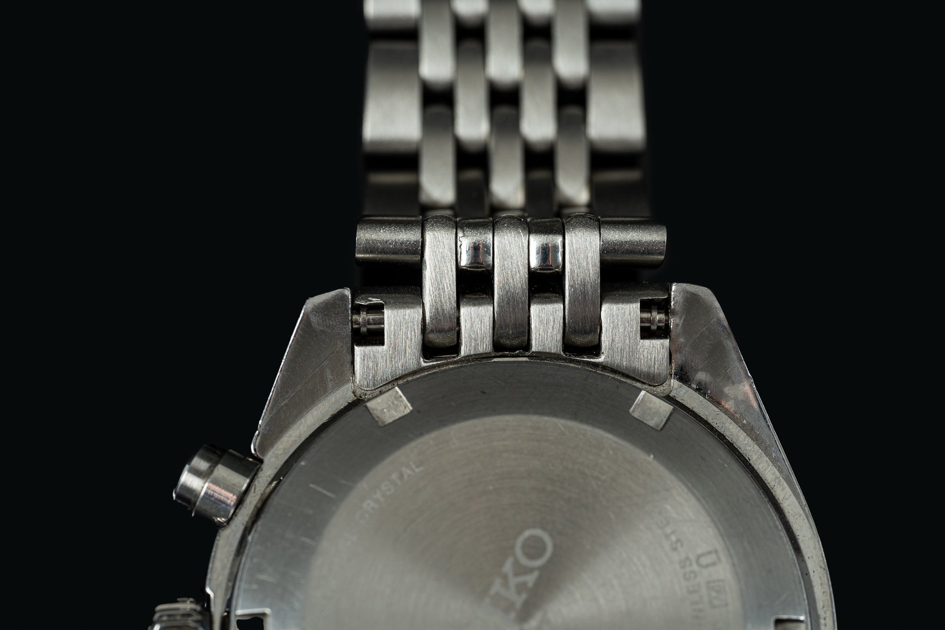 Stainless steel Seiko Speedtimer watch with beads of rice metal bracelet, showing brushed case back and polished link details