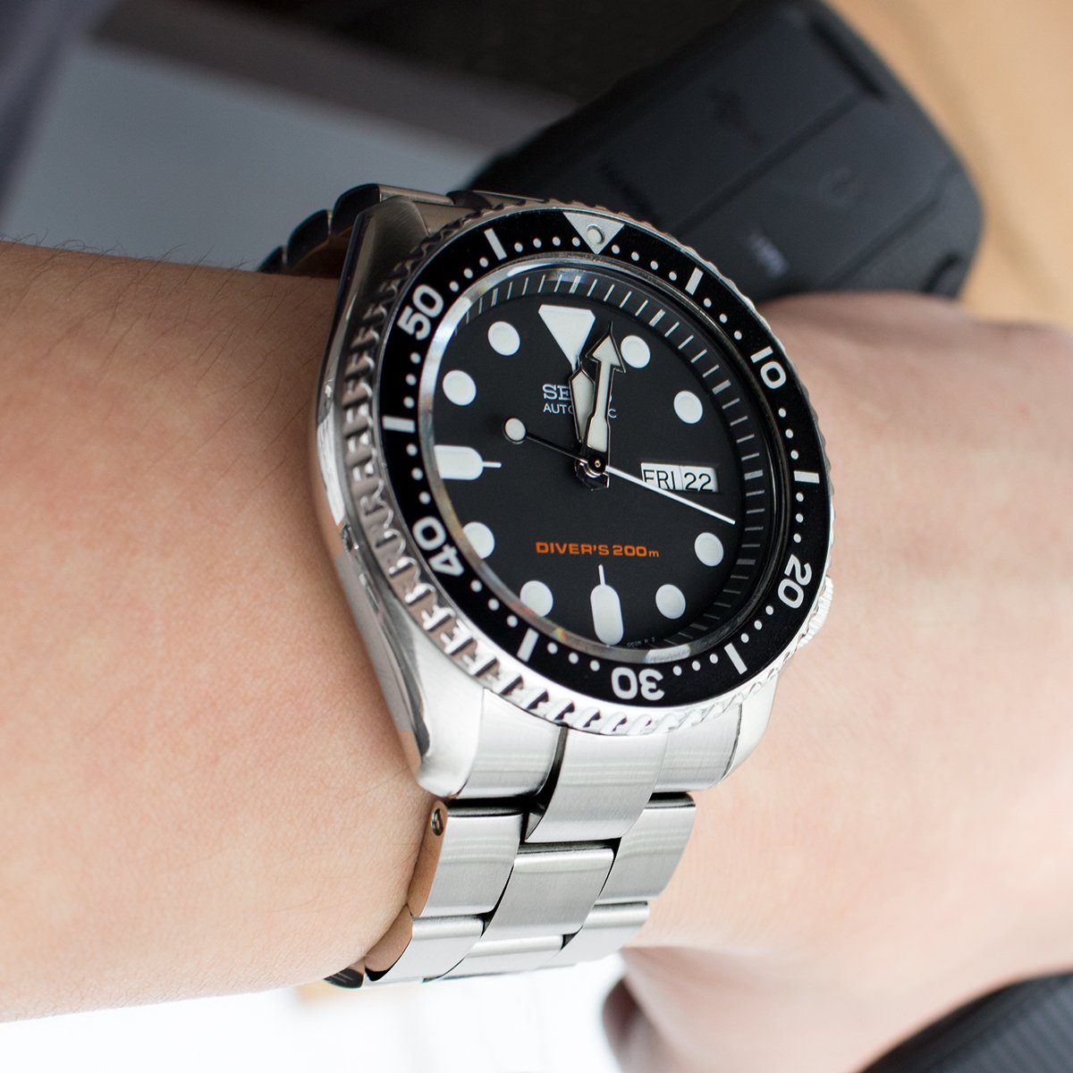 Silver stainless steel Super-O Boyer bracelet on Seiko SKX007 dive watch with black dial and 200m water resistance rating