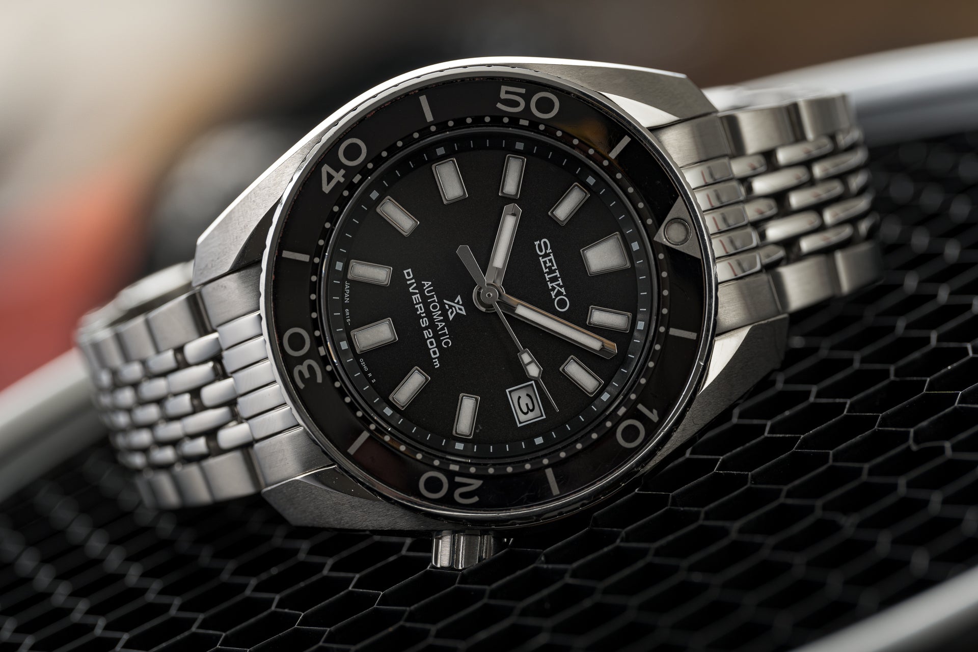 Seiko Sumo automatic diver watch with black dial, stainless steel beads of rice bracelet, and tachymeter bezel