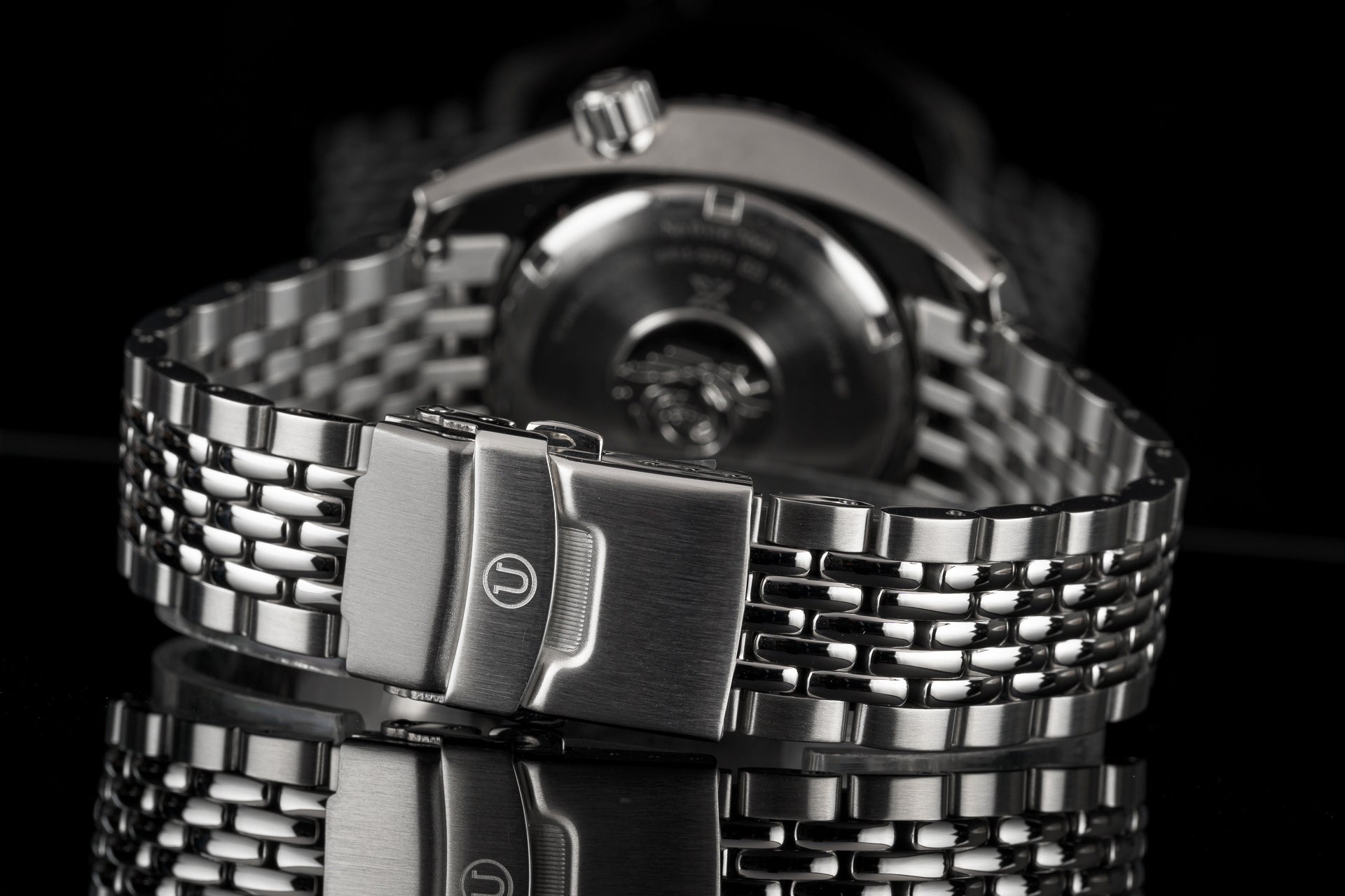 Stainless steel watch with beads of rice bracelet and fold-over clasp, detailed black and white product photography