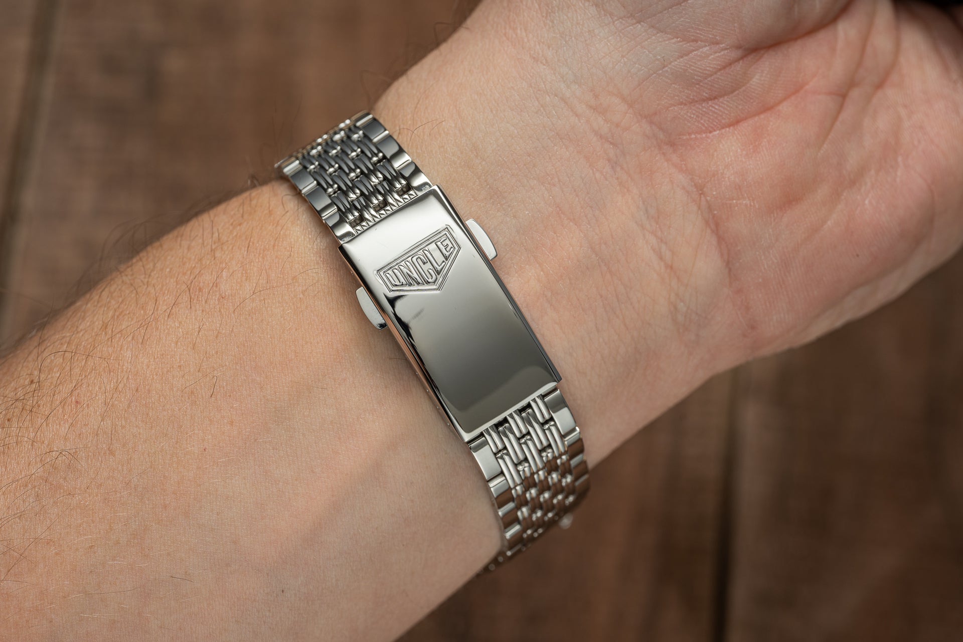 Stainless steel beads of rice bracelet with shield logo clasp worn on wrist