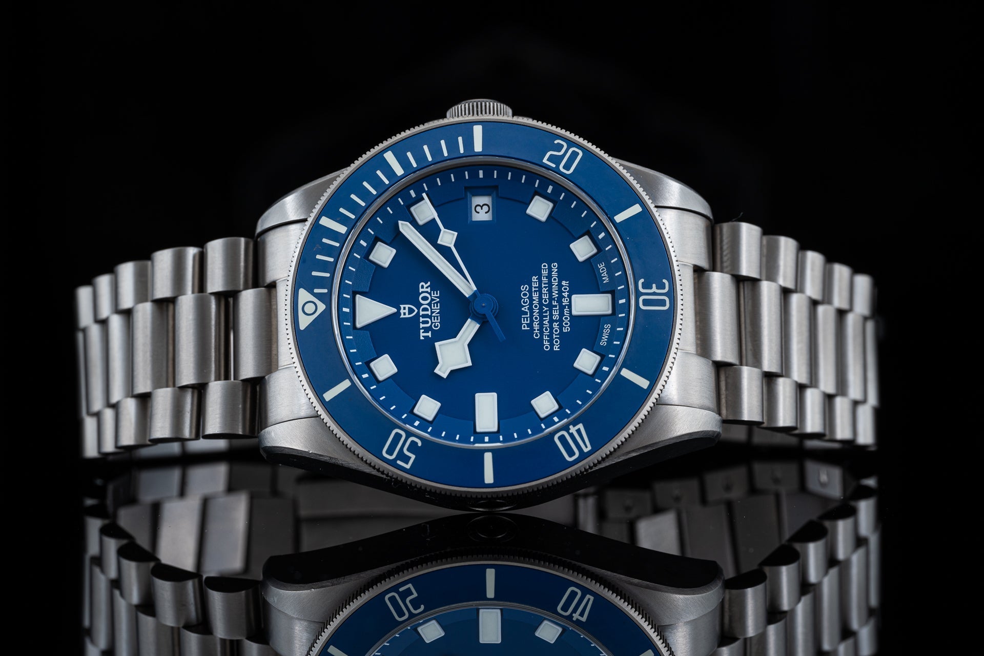 Tudor Pelagos 42mm titanium watch with blue dial, steel bracelet and rotating bezel on black background