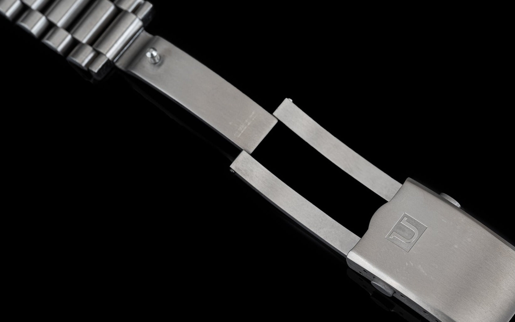Titanium watch bracelet with solid end links and clasp mechanism for Tudor Pelagos 42mm, featuring brushed metal finish