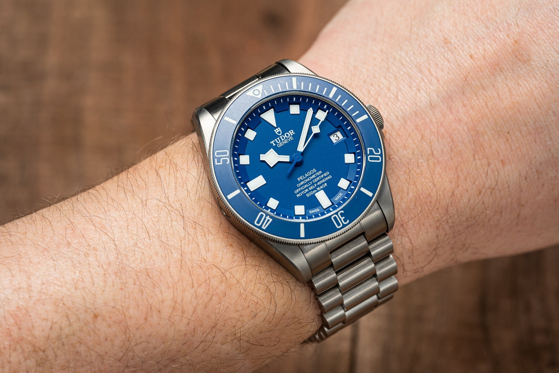 Titanium bracelet with three-link design and secure clasp fitted on Tudor Pelagos 42mm dive watch with blue dial