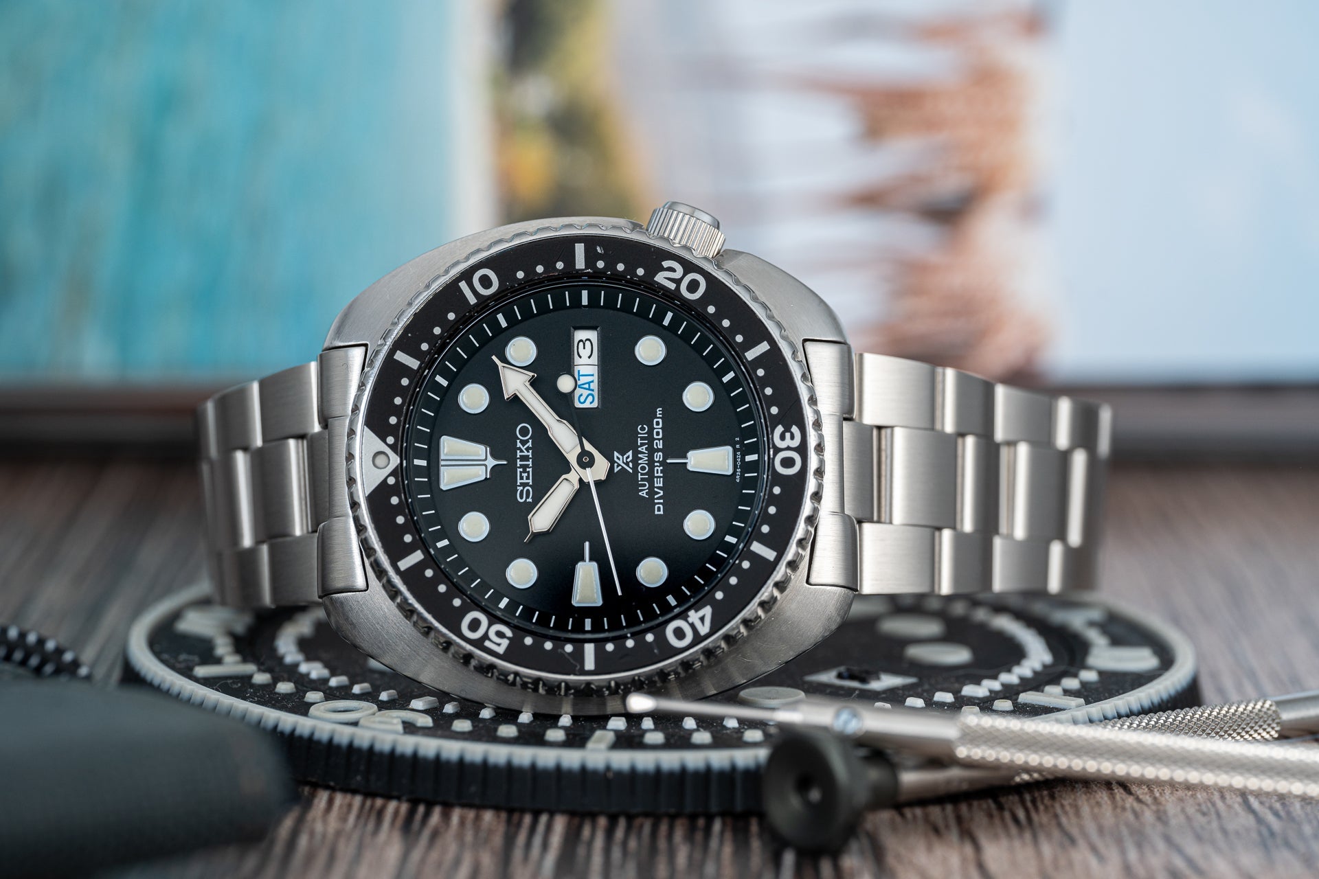 Seiko Prospex stainless steel dive watch with black dial, day-date window, and matching steel bracelet on Uncle Senator fabric strap