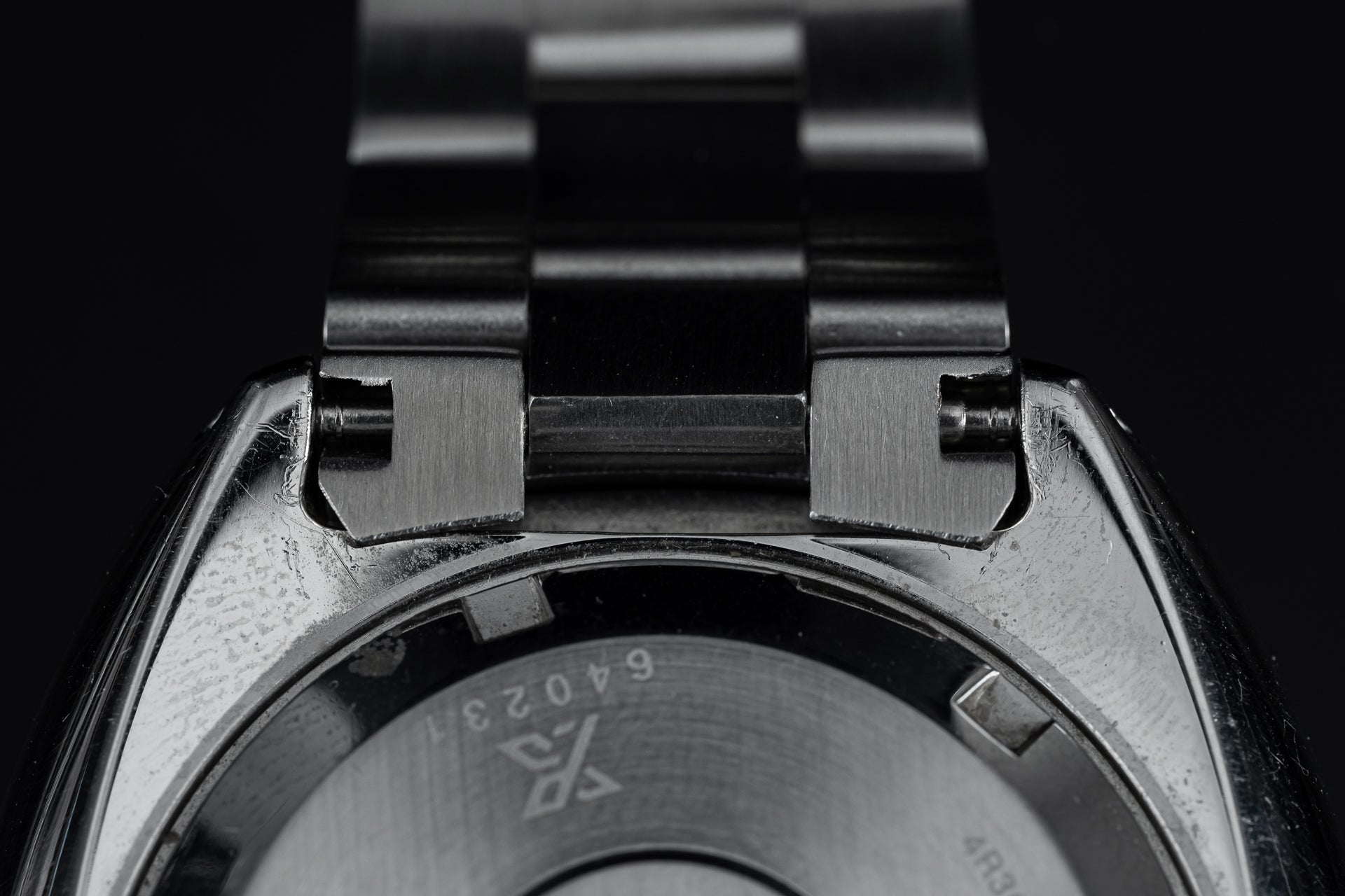 Stainless steel dive watch bracelet with solid end links and center links, close-up detail view
