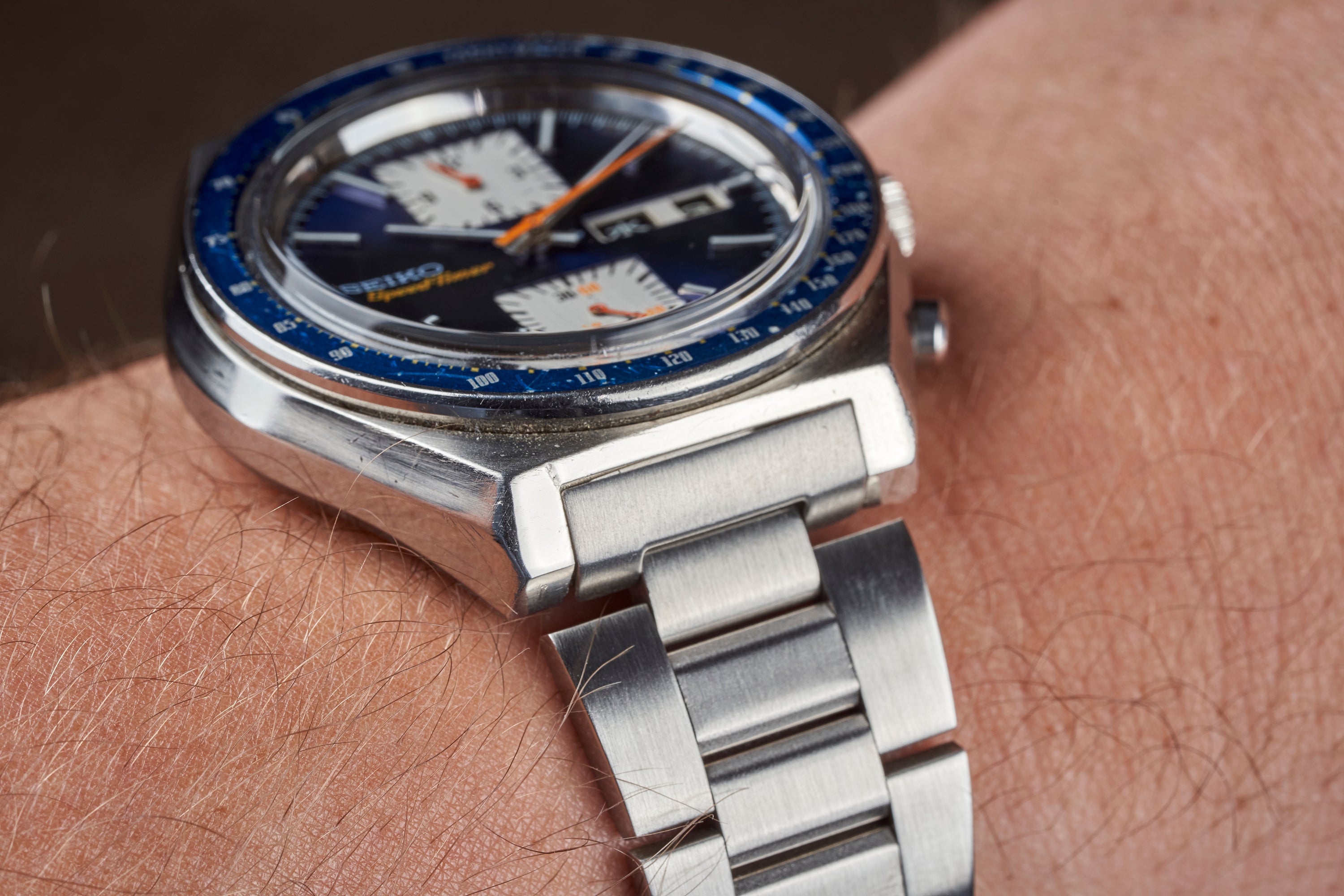 Vintage Seiko 6138 chronograph watch with blue bezel and steel tapered bracelet on wrist