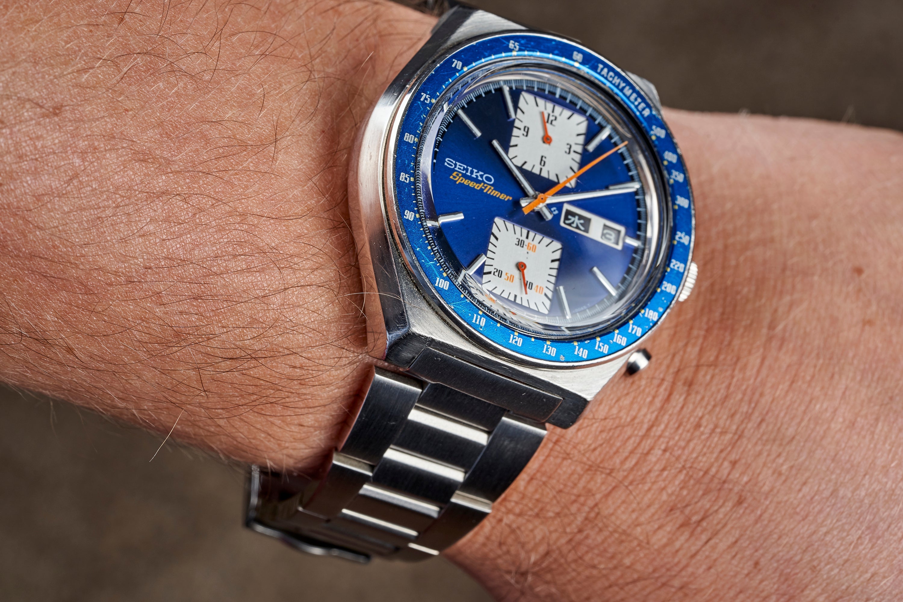 Seiko 6138 chronograph watch with blue dial and bezel worn on wrist with two-tone metal bracelet