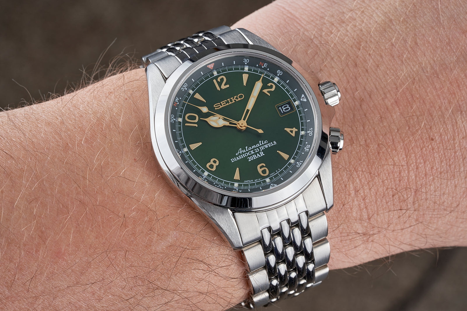 Seiko SARB017 Prospex automatic watch with green dial, gold indices, date window, and stainless steel bracelet on wrist