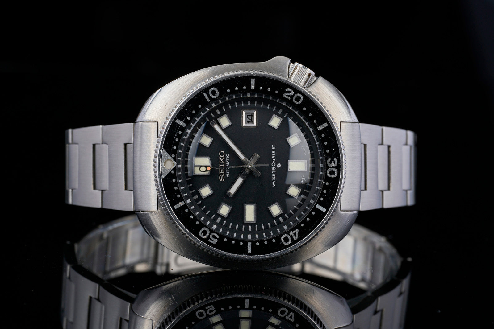 Seiko 6105 automatic diving watch with stainless steel H-link bracelet and black dial featuring luminous hour markers