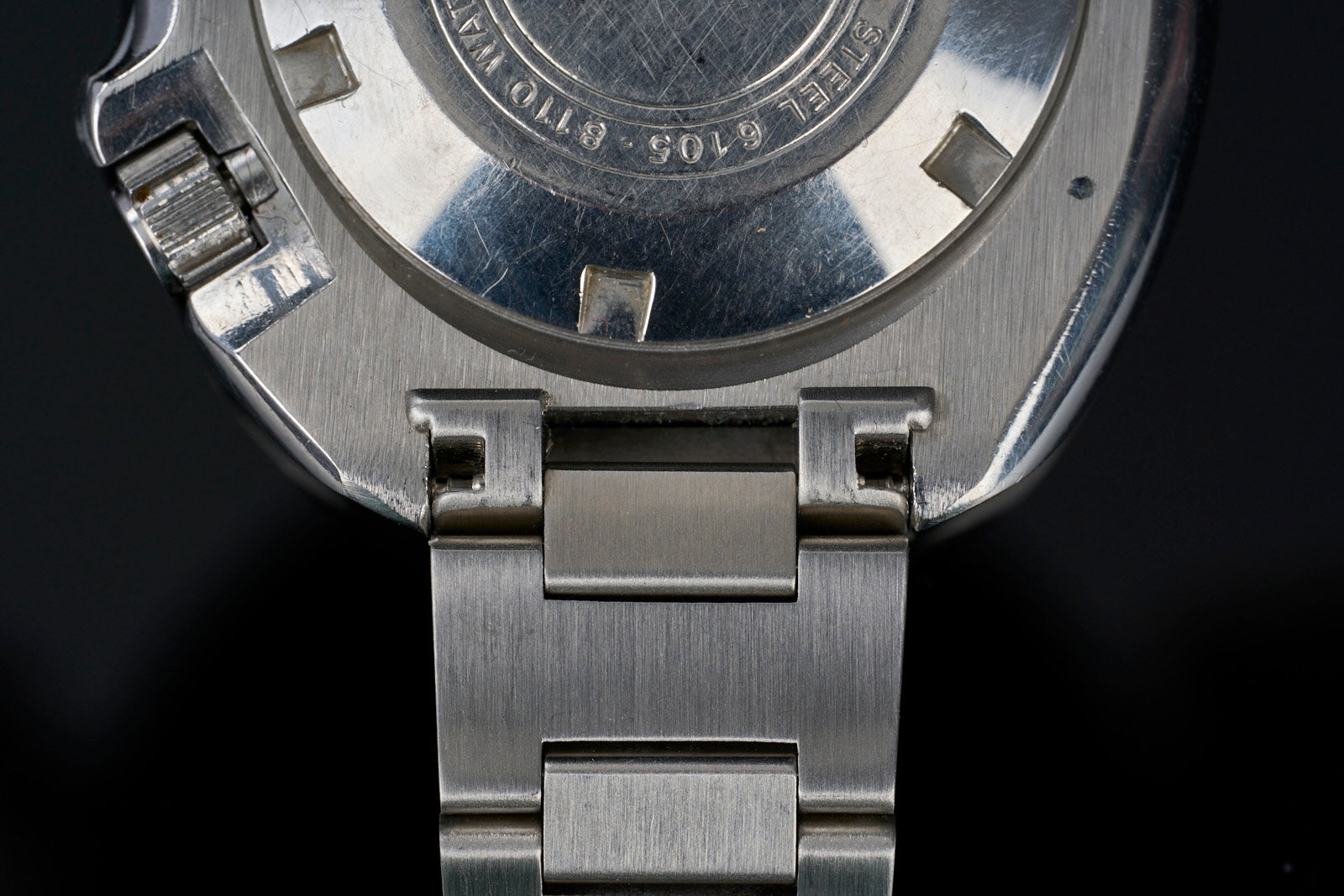 Stainless steel H-Link bracelet for Seiko 6105 dive watch, overhead view showing brushed metal links and connector hardware