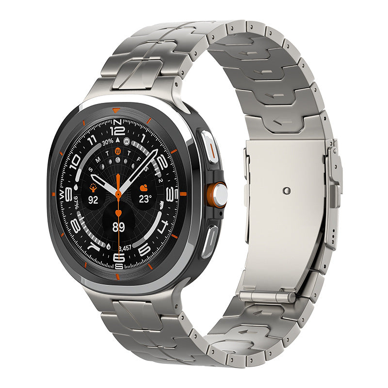 Titanium smartwatch with black dial, orange accents, and stainless steel link bracelet featuring GPS and fitness tracking display