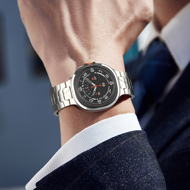 Men's smartwatch with black dial and stainless steel bracelet worn on wrist with business suit