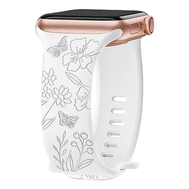 White silicone Apple Watch band with floral butterfly design and rose gold connector on black watch case