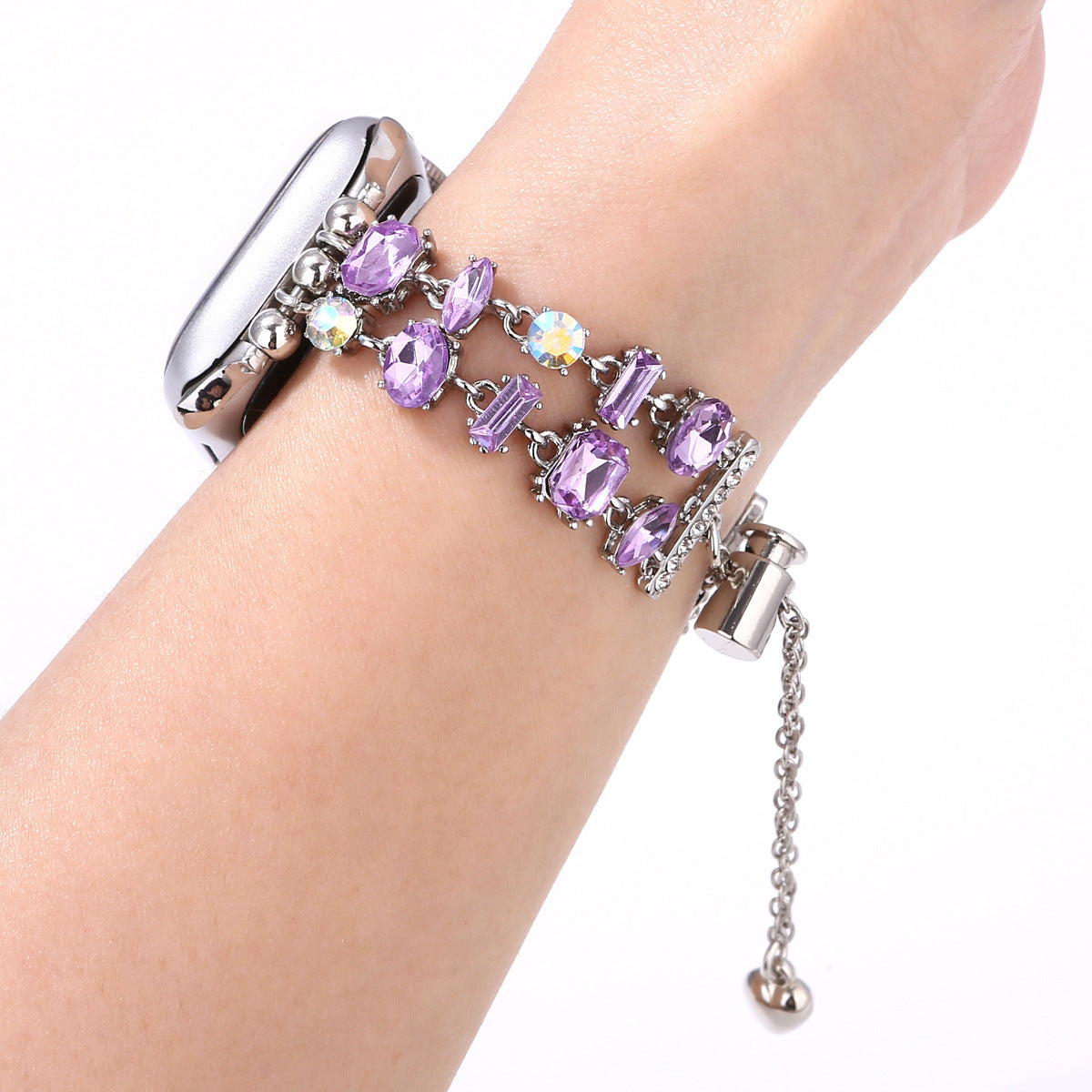 Silver-tone charm bracelet with purple crystals and AB rhinestones worn with Apple Watch on wrist