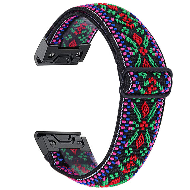 Colorful Gaucho Weave QuickFit watch band with vibrant red, green, blue, and pink geometric pattern and black hardware