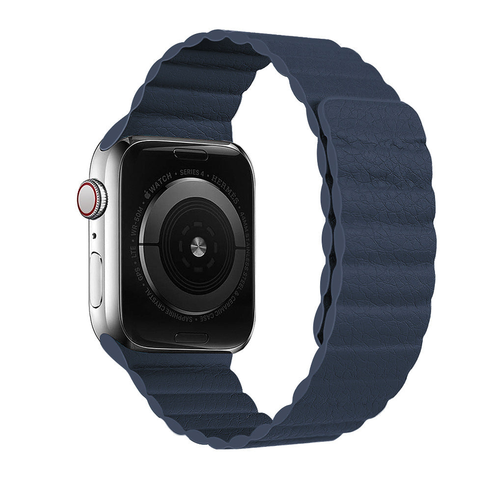 Smartwatch with silver stainless steel case and navy leather loop band, featuring digital display and red crown button