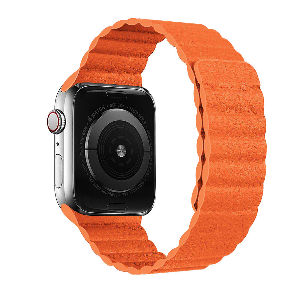 Smartwatch with silver stainless steel case and bright orange textured leather loop band, featuring digital display and red accent crown