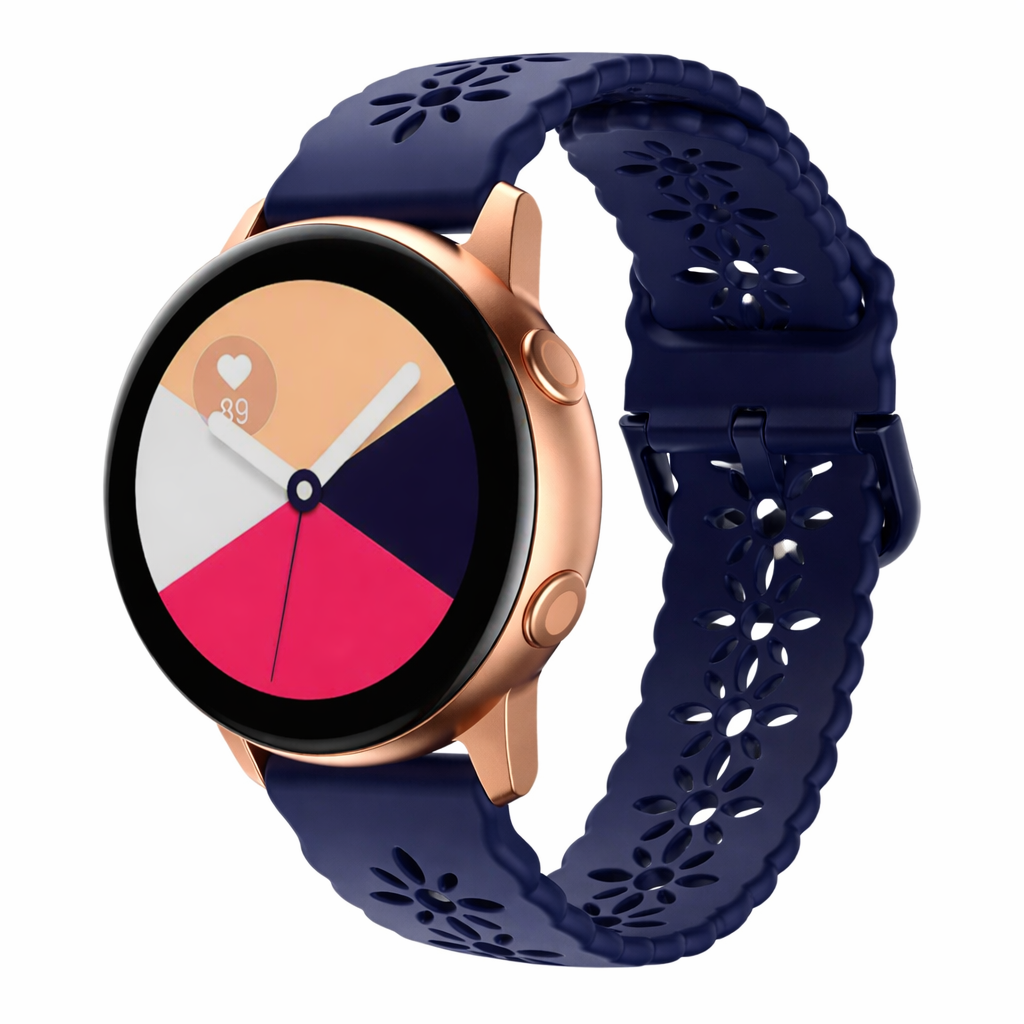 Rose gold smartwatch with navy blue perforated silicone floral band, colorful pie chart watch face, and heart rate monitor display