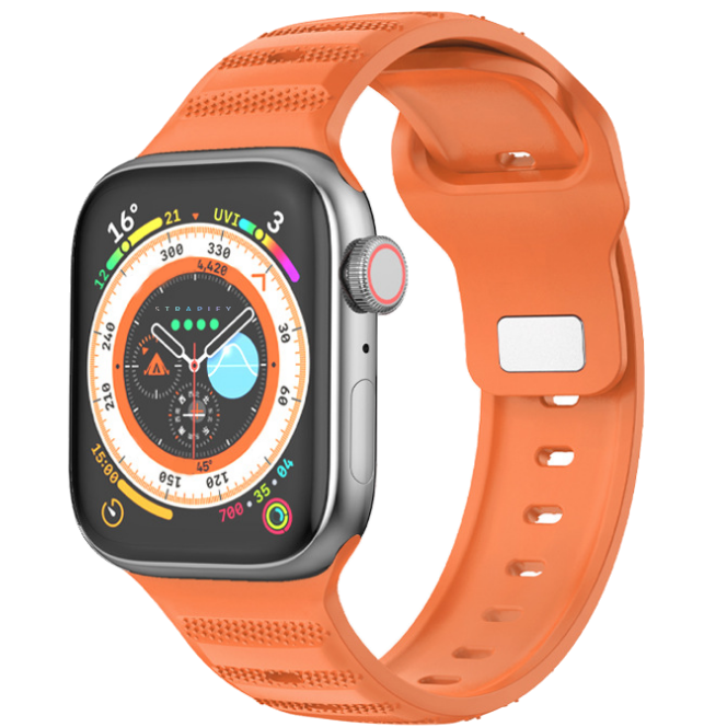 Orange ridged sports rubber band with black smartwatch featuring colorful compass and UV monitoring dial display