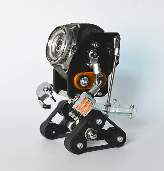 Black RoboTank watch stand with orange accents, mechanical robot design holding round watch face on articulated metal arms