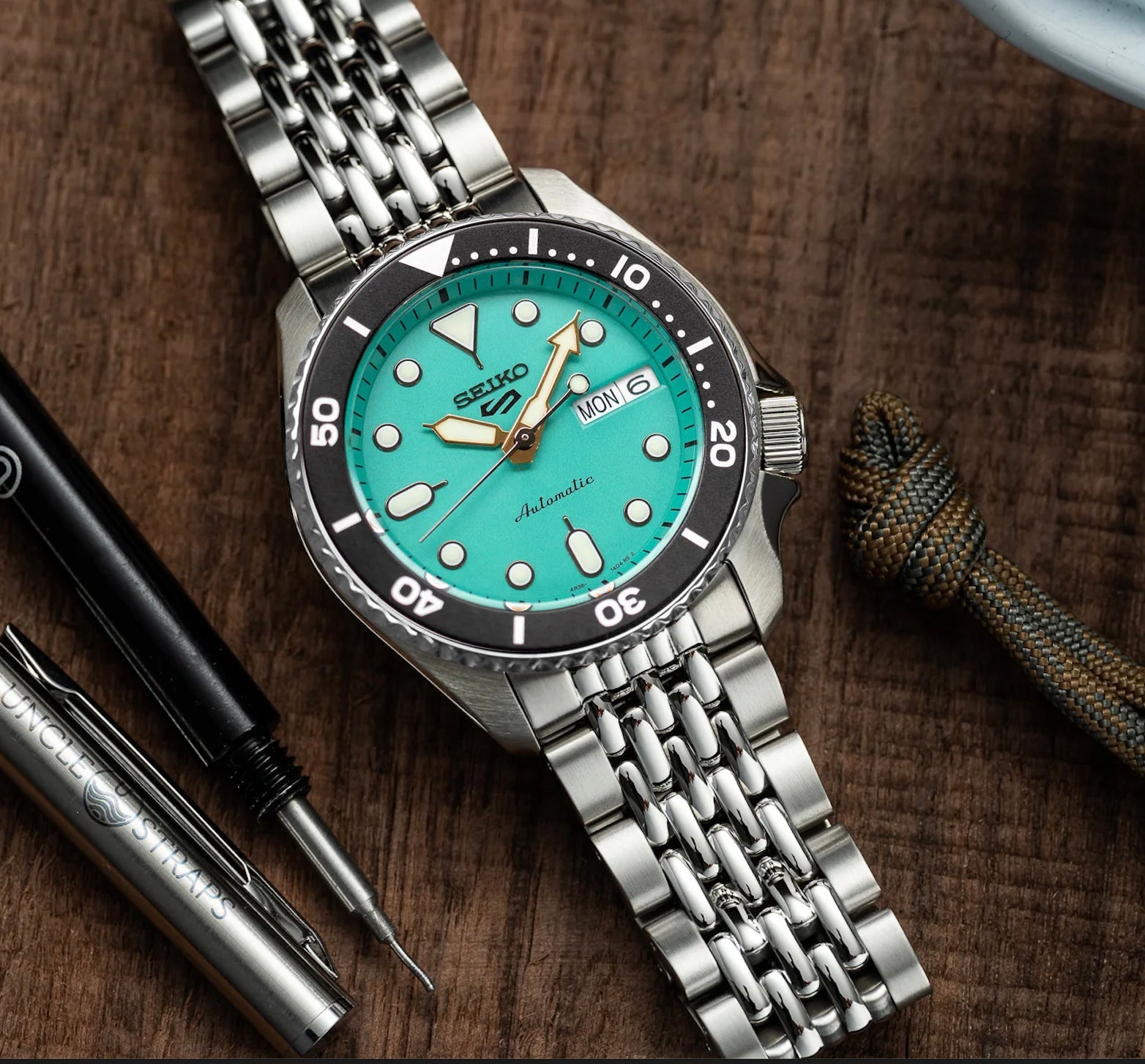 Seiko 5 Sports automatic watch turquoise dial stainless steel bracelet day date window bezel