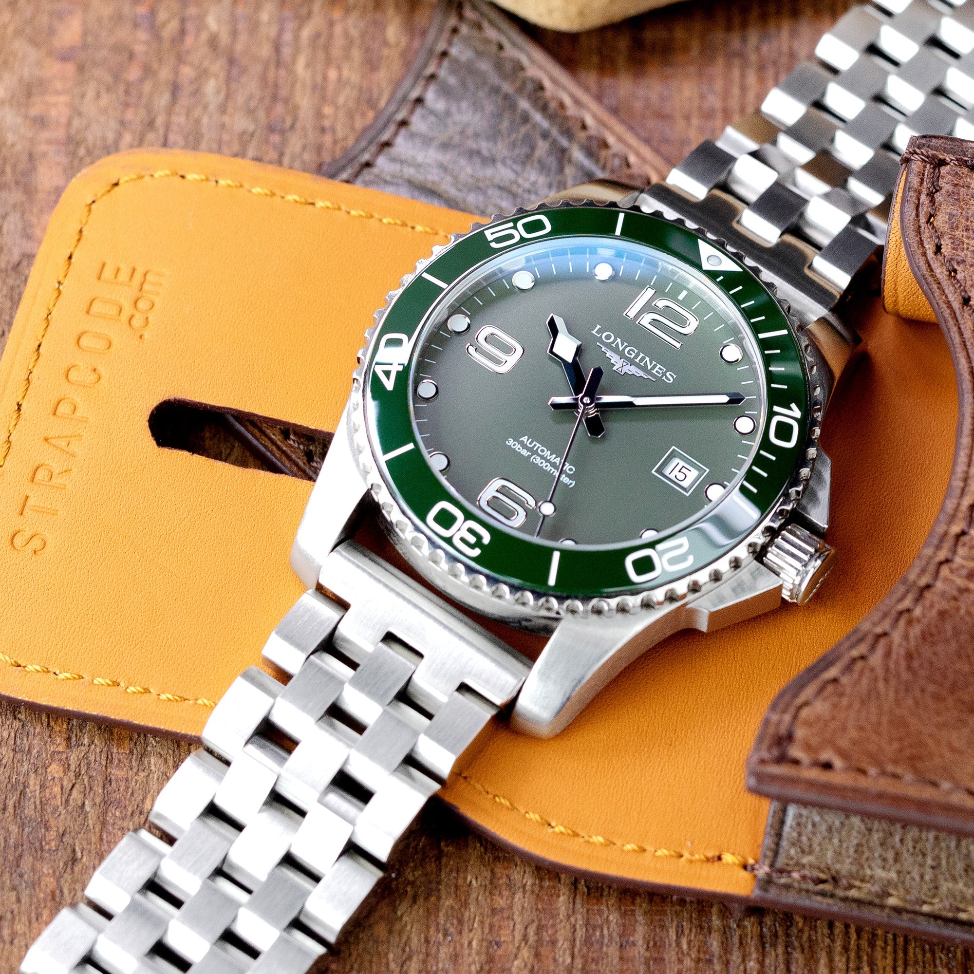 Strapcode Engineer Bracelet with V-Clasp on Longines dive watch with green bezel and steel jubilee band