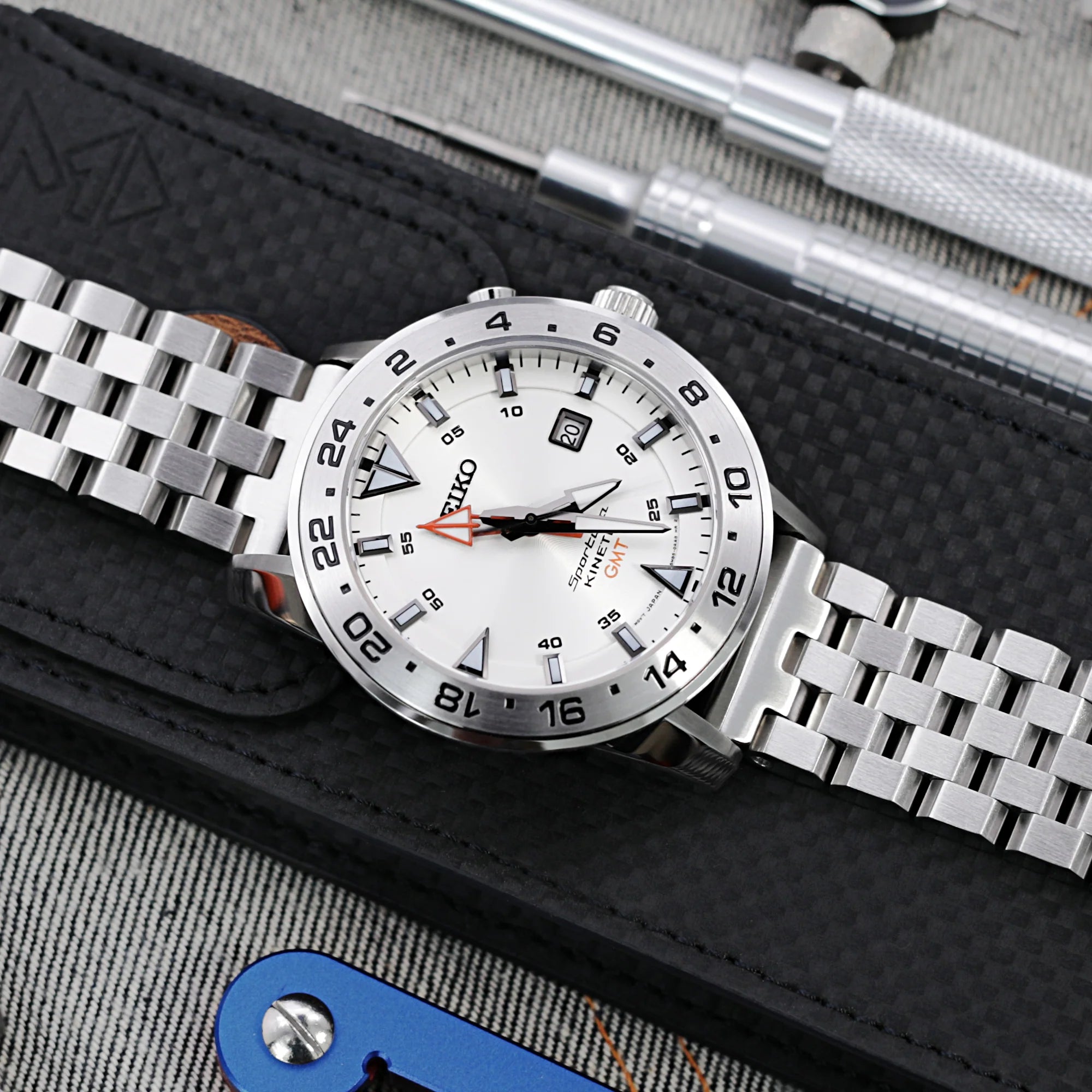 Seiko Prospex white dial GMT watch with stainless steel Engineer bracelet and V-clasp on black background