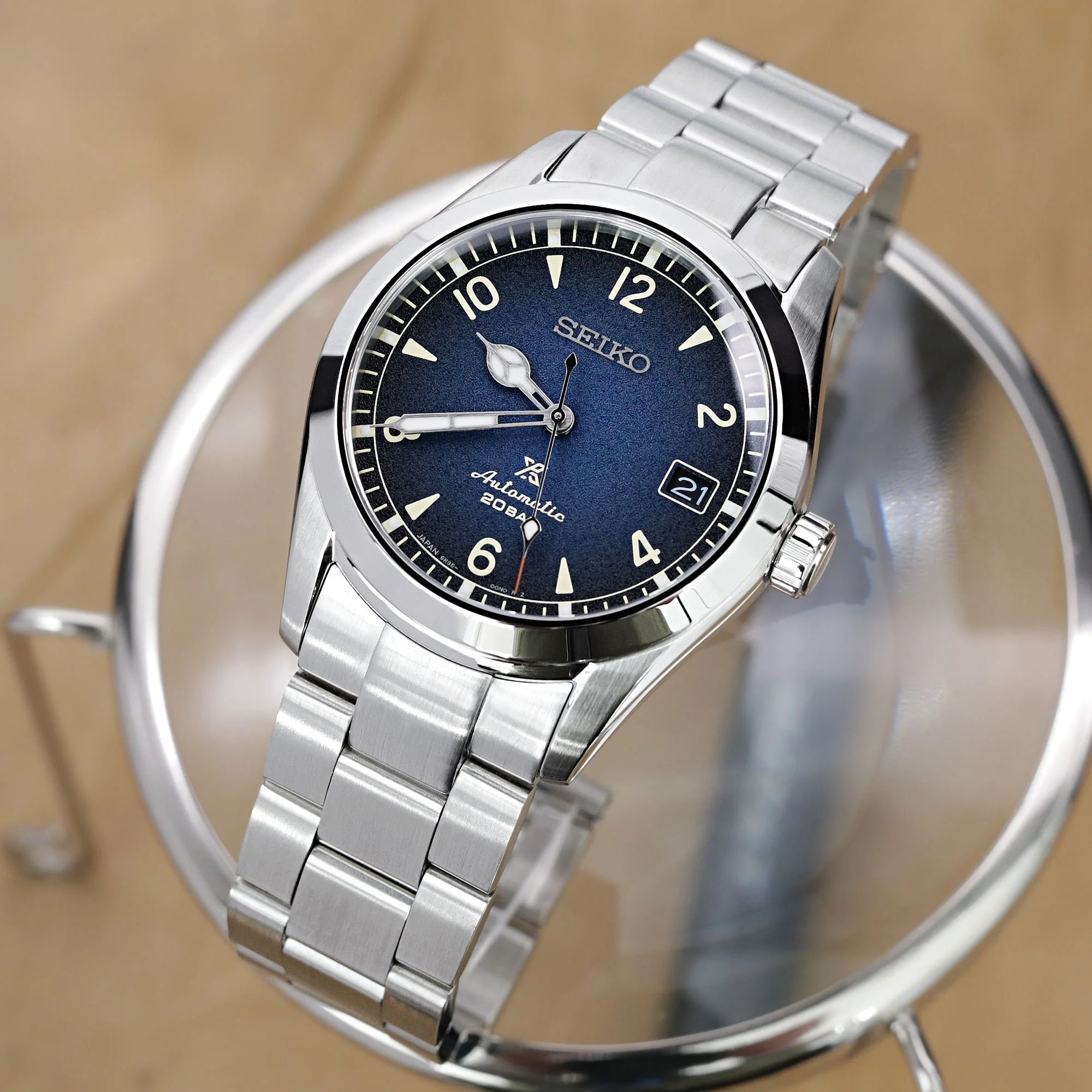 Seiko Alpinist SARB017 automatic watch with dark blue dial, stainless steel case and bracelet, date window, on display stand