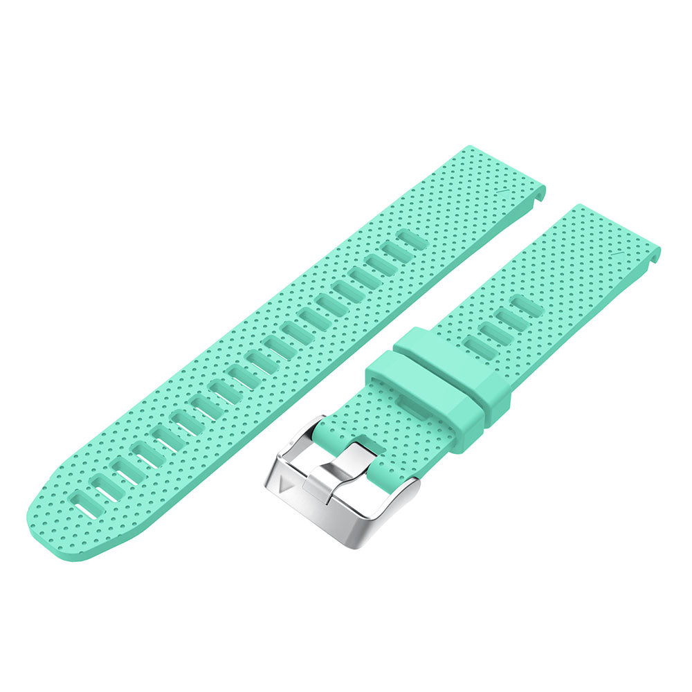 Mint green silicone smartwatch band with perforated design, quick-fit release bars, and silver stainless steel buckle hardware