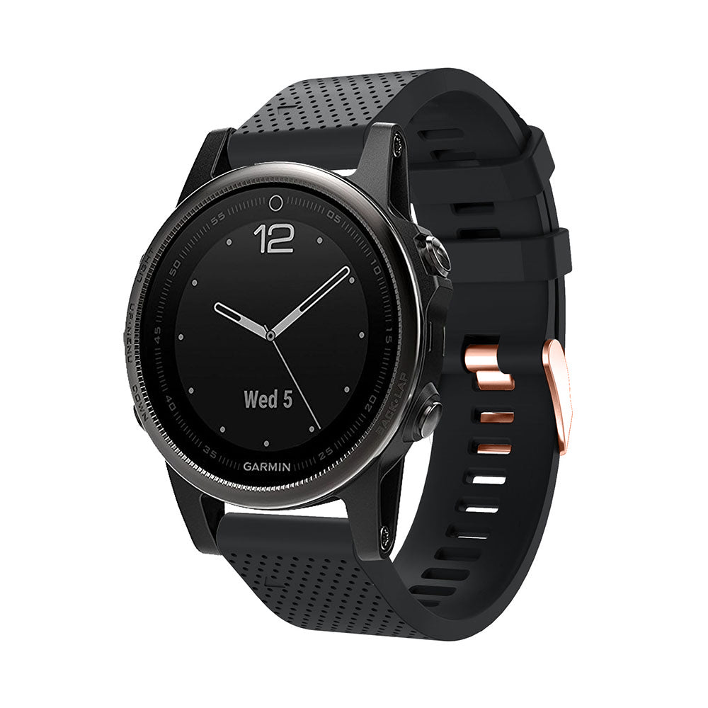 Garmin smartwatch with black silicone band, white hands, date display, and rose gold hardware accents