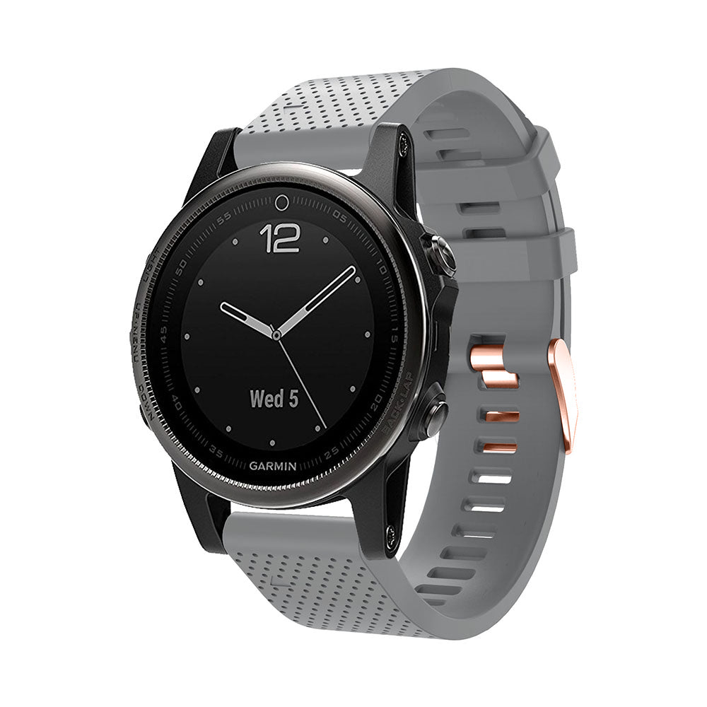 Garmin smartwatch with gray perforated silicone band and rose gold hardware, black dial displaying Wed 5