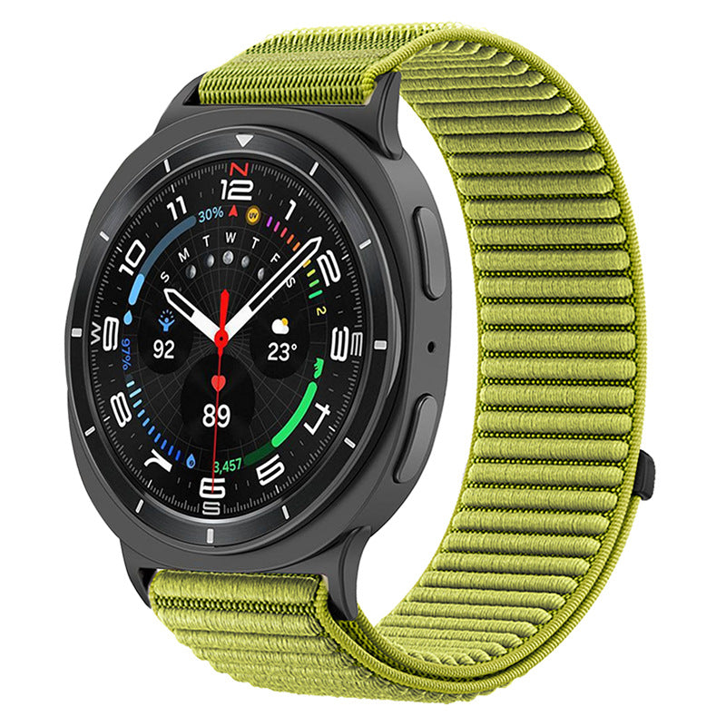 Black smartwatch with lime green sports loop band, displaying fitness metrics and weather on AMOLED dial