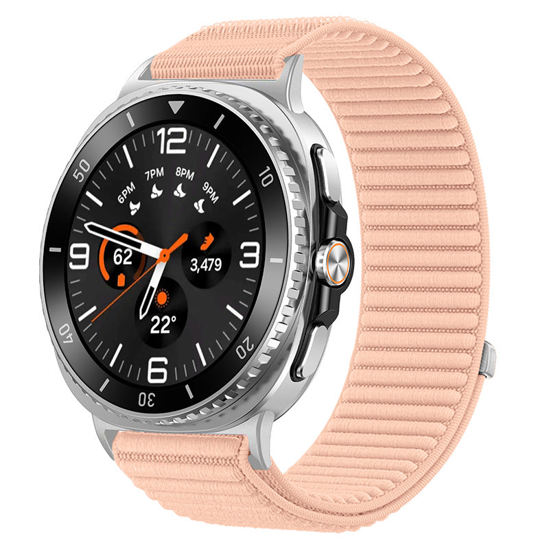 Silver smartwatch with black dial, orange accents, and peach sports loop band displaying time and health metrics