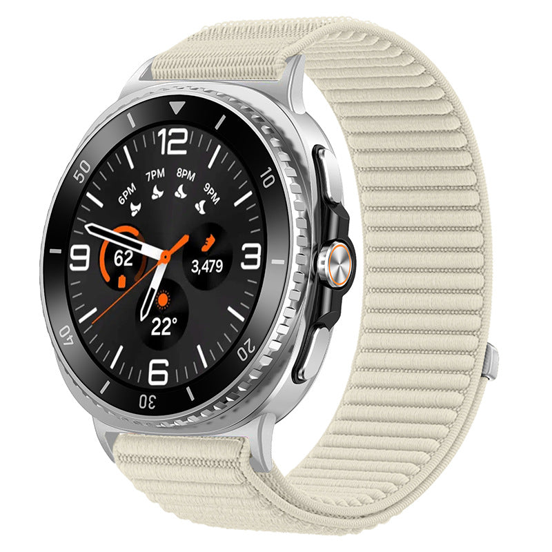 Silver Galaxy Watch with black dial, orange accents, and cream sports loop band showing fitness metrics