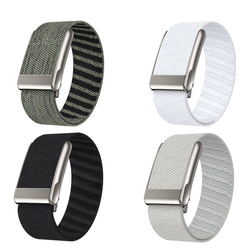 Four Whoop 5 fitness tracker loop bands in sage green, white, black, and gray with woven nylon material and metal closures