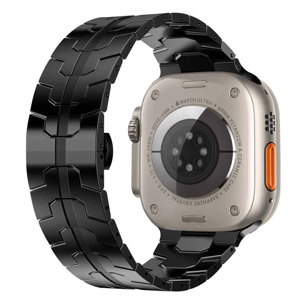 Titanium smartwatch with black stainless steel armor bracelet band, ceramic back, orange action button visible