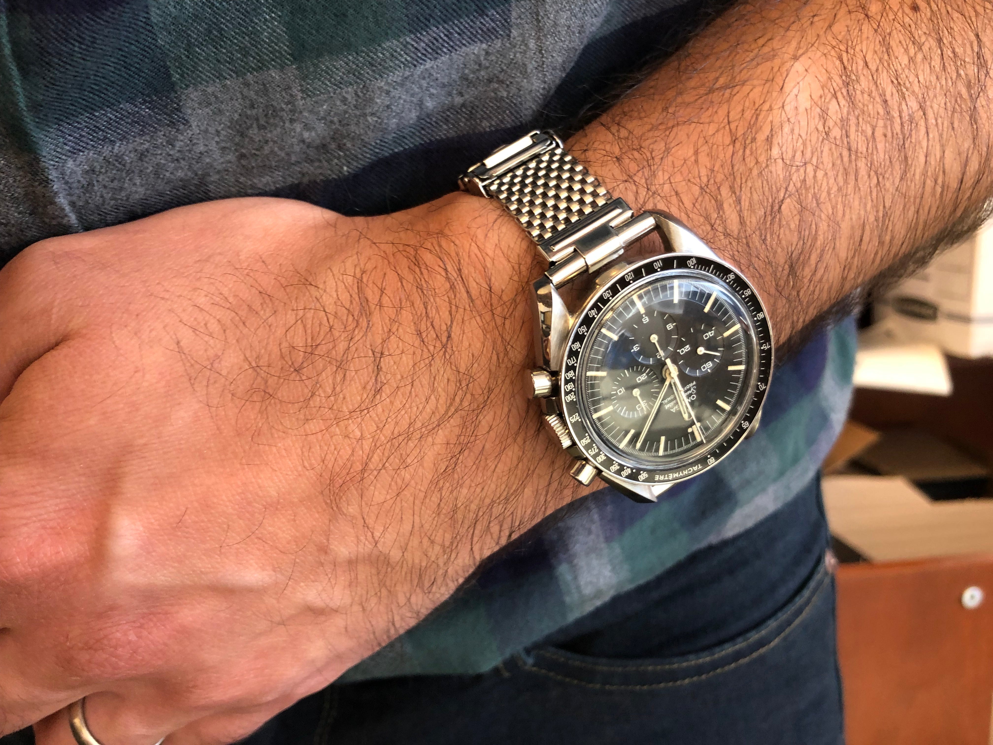 Men's stainless steel mesh watch bracelet with straight end links, silver-tone finish on wrist