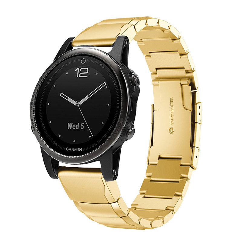 Black Garmin smartwatch with gold QuickFit link bracelet and black dial displaying Wednesday date