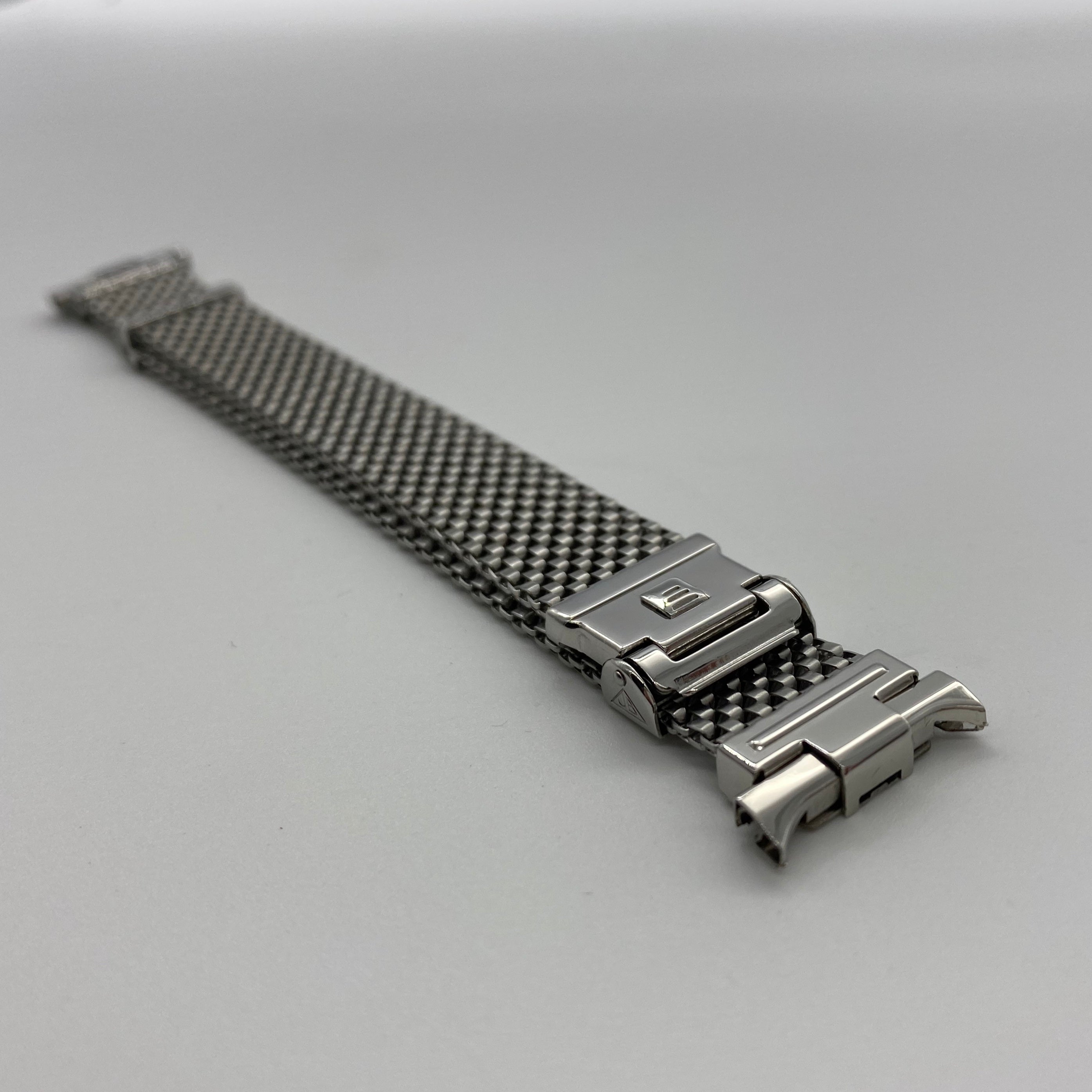 Stainless steel mesh watch bracelet with polished horned end links and push-button clasp closure