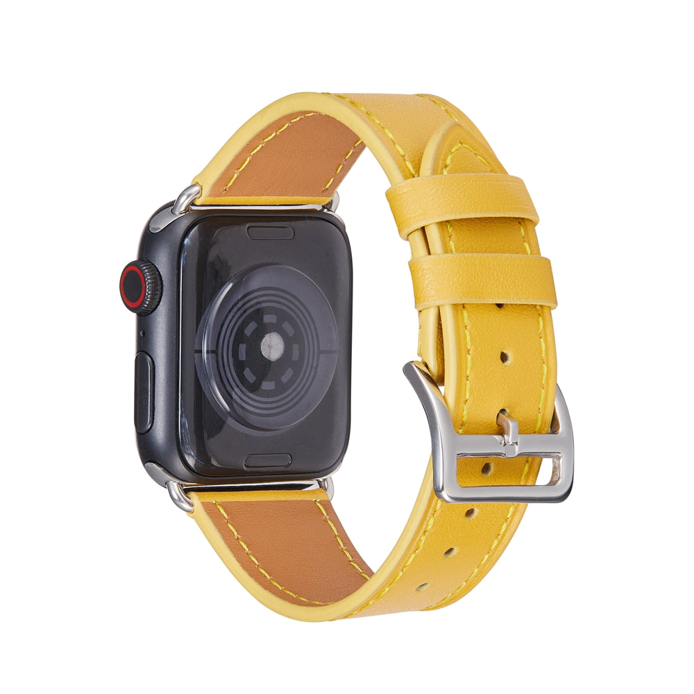 Yellow leather Apple Watch band with tan interior, silver buckle and connector on black smartwatch face with red crown