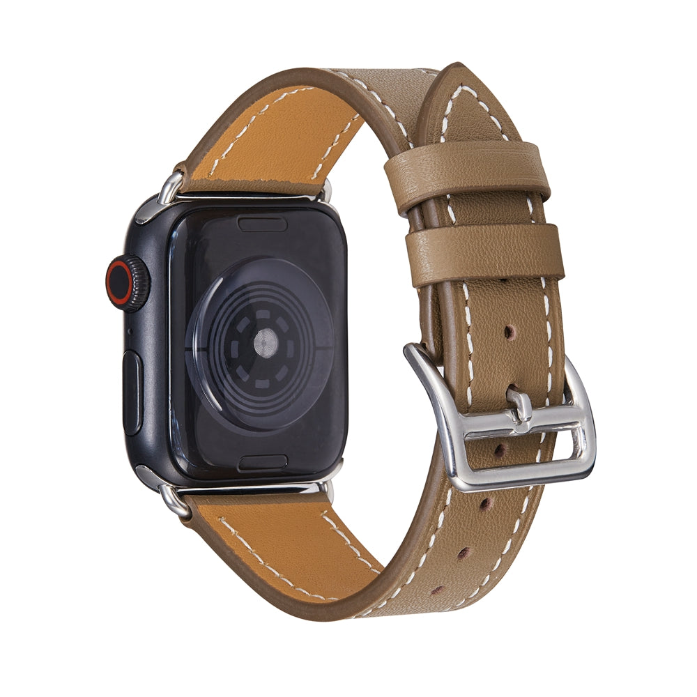 Black smartwatch with red digital crown and tan leather single tour band featuring white stitching and silver buckle