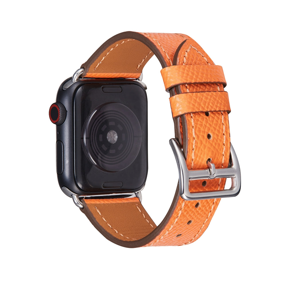 Black Apple Watch with orange leather single tour band, silver buckle and white stitching detail
