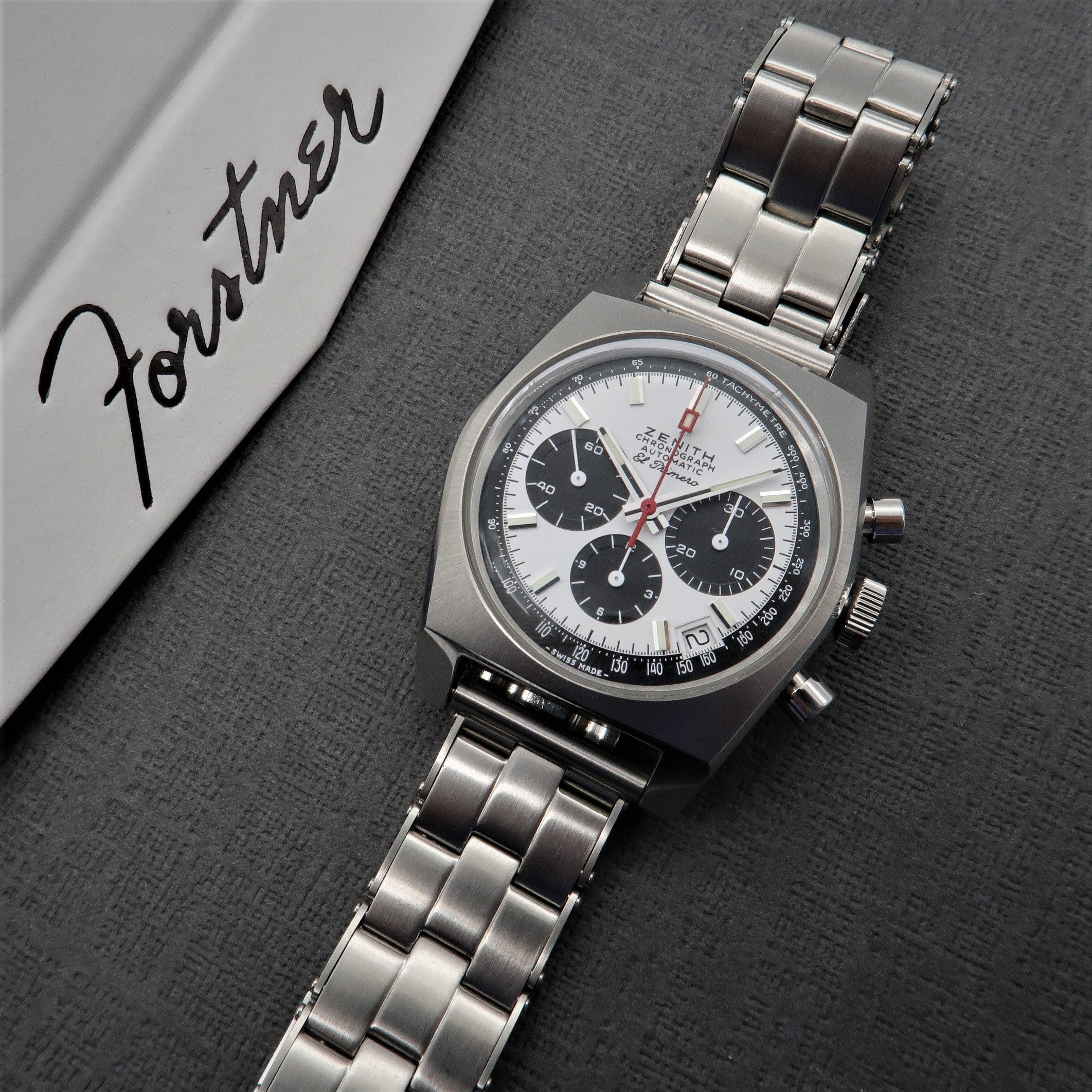 Vintage Zenith chronograph watch with steel bracelet and panda dial featuring black subdials on white background