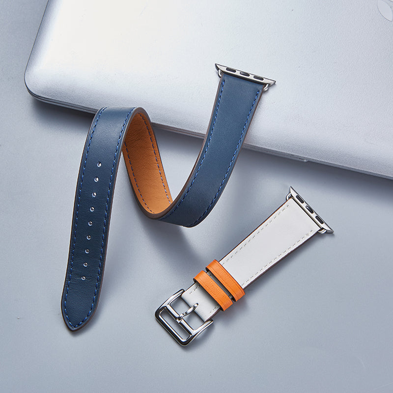 Apple Watch leather bands with double tour navy blue and white straps featuring orange accents and silver connectors