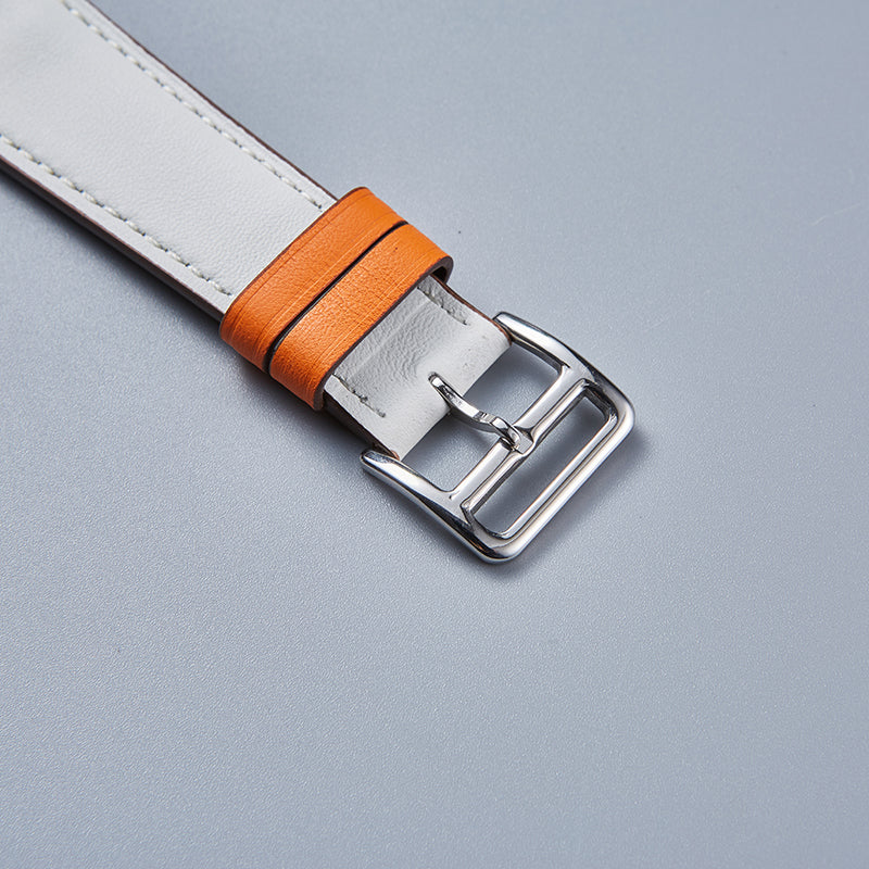 White and orange leather Apple Watch band with silver buckle and decorative orange wraparound accent detail